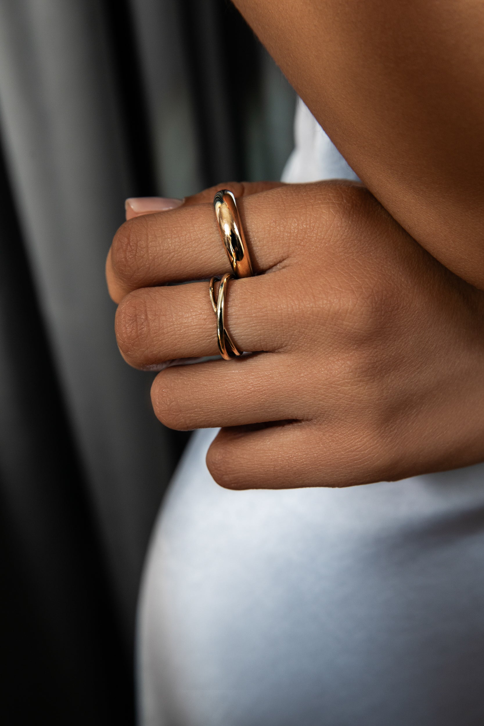 Avony Modeling Bold Gold Holiday Edit featuring the thick gold tapered band and crossover ring. Shop the bold gold colleciton