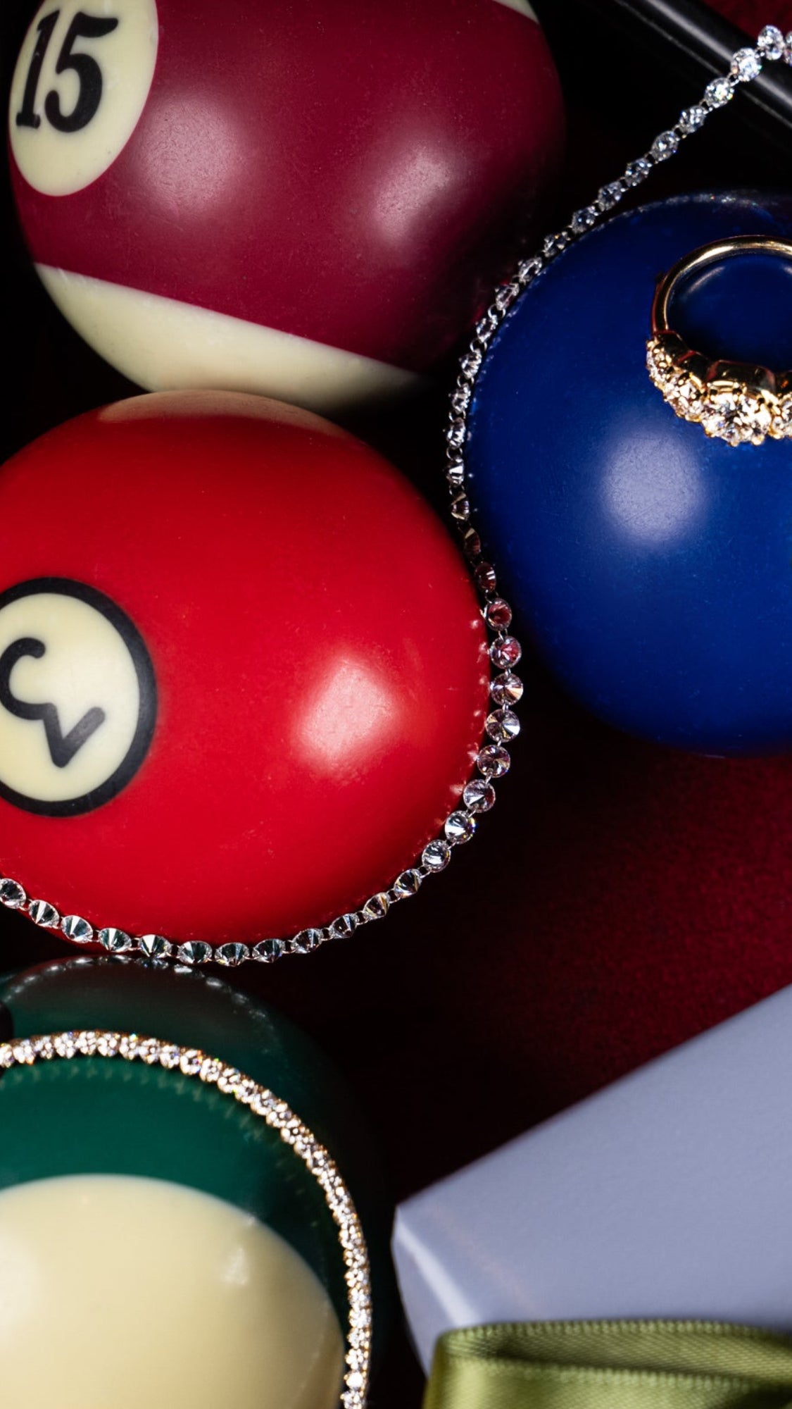 Billiard balls including the 15-ball and 3-ball, accented with a diamond-style chain and a diamond ring.