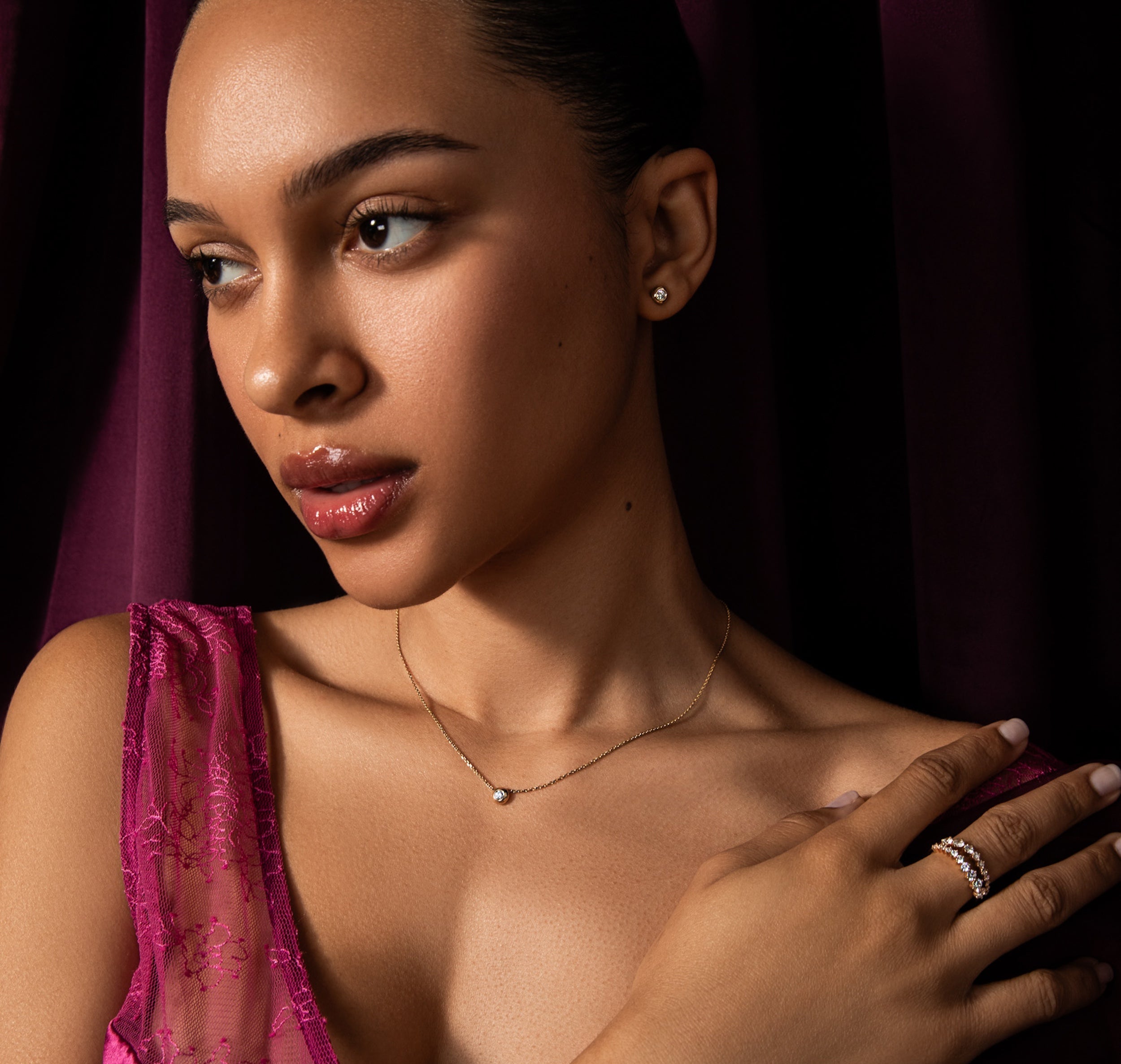 model wearing the holiday free diamond necklace and studds. A 3mm round diamond is set in a solid 14k gold bubble setting on a delicate gold 16" chain and in a pair of studs. Spend $1,000+ choose the free necklace or studs. Spend $2,000+ and get the necklace plus the holiday diamond studs. A free gift for you. automatically added to qualifying carts.