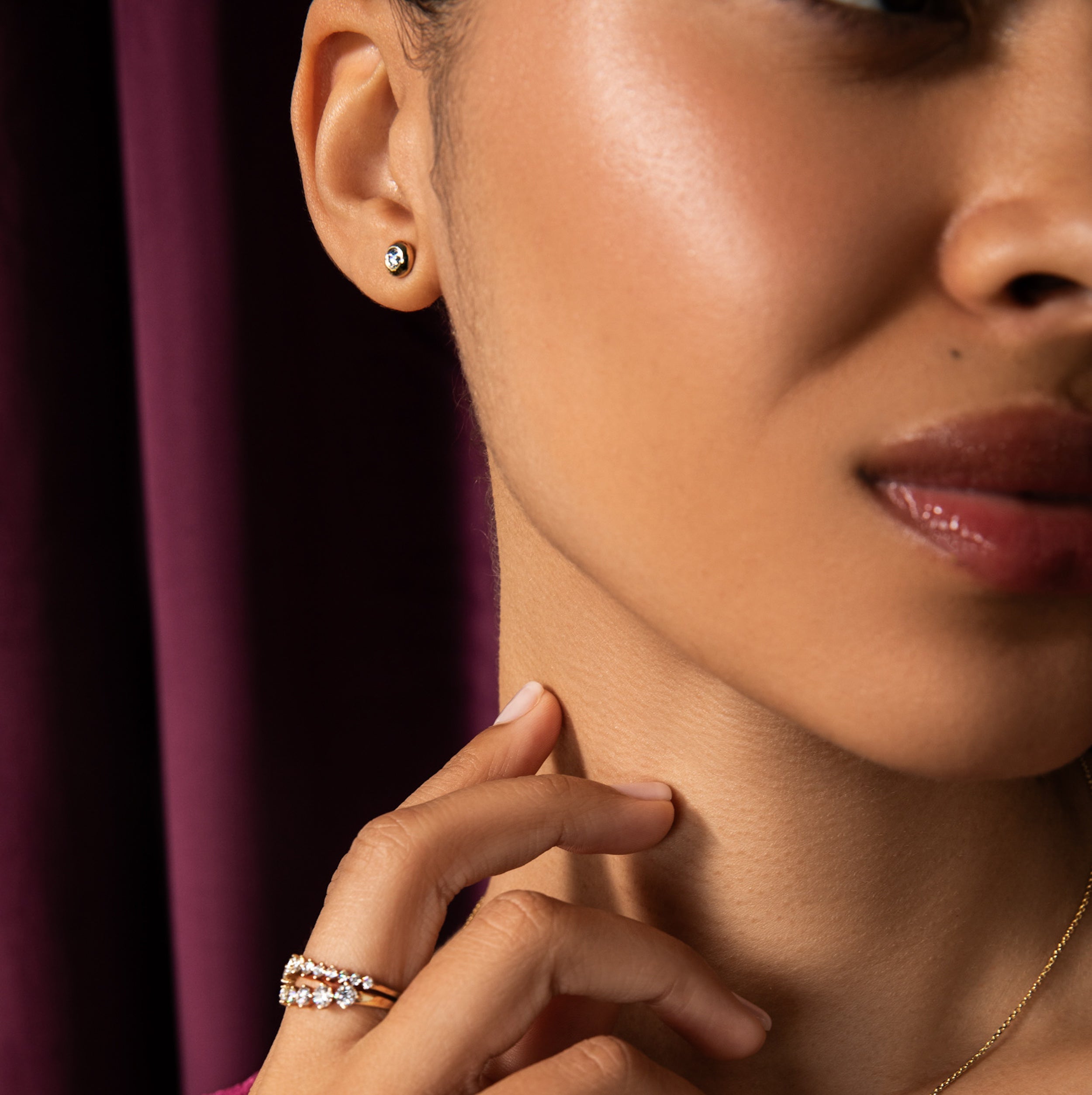 model wearing the holiday free diamond studs. A 3mm round diamond is set in a solid 14k gold bubble setting on standard gold posts. Spend $1,000+ get a pair of studs or spend $2,000+ and get the holiday necklace and holiday diamond studs. A free gift for you. automatically added to qualifying carts.