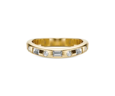 Gold band ring featuring alternating round and baguette-cut diamonds.