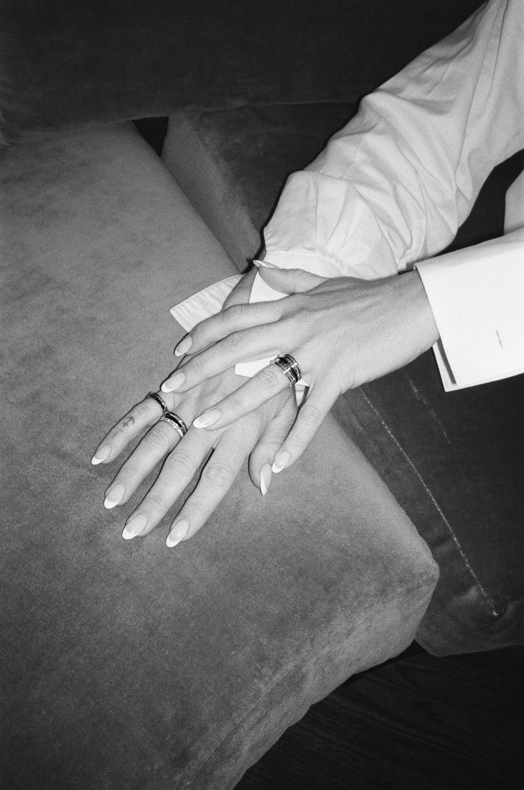 Zosia Mamet's hand modeling her collections diamond and enamel rings. Styled for fall in a black and white image. Shop black patina and enamel styes - moody and romantic for fall