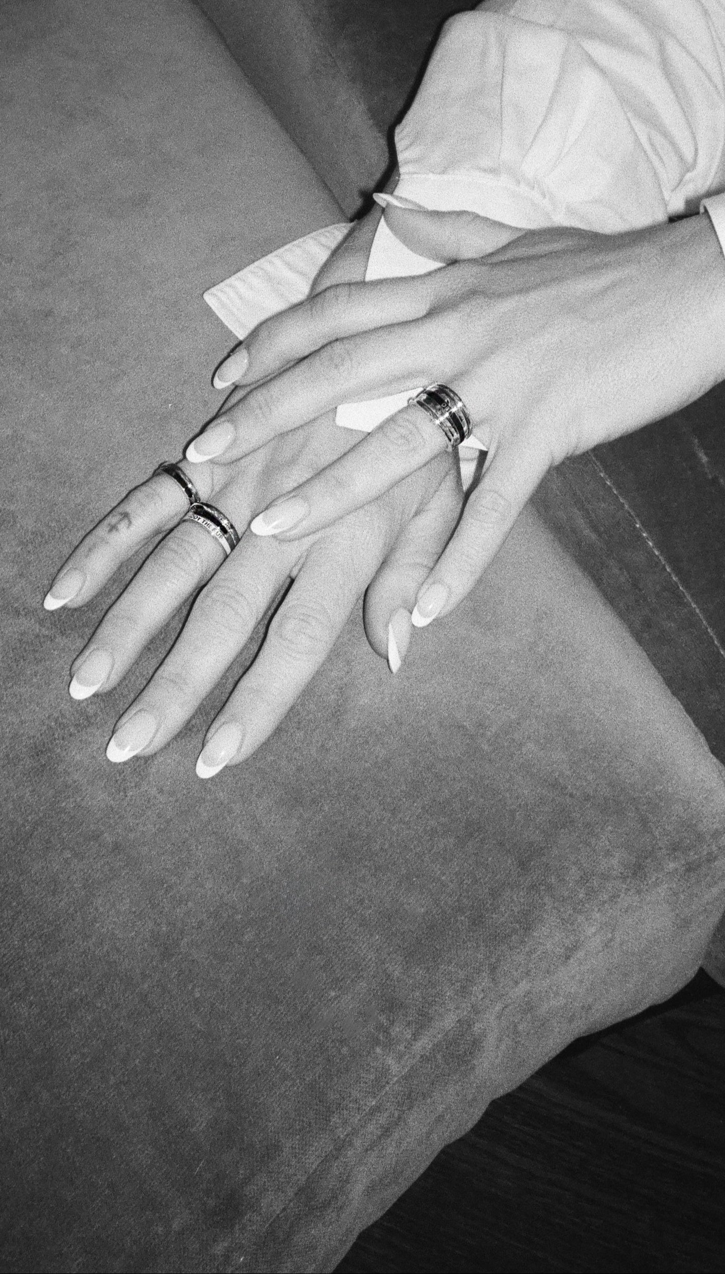 Zosia Mamet's hand modeling her collections diamond and enamel rings. Styled for fall in a black and white image. Shop black patina and enamel styes - moody and romantic for fall