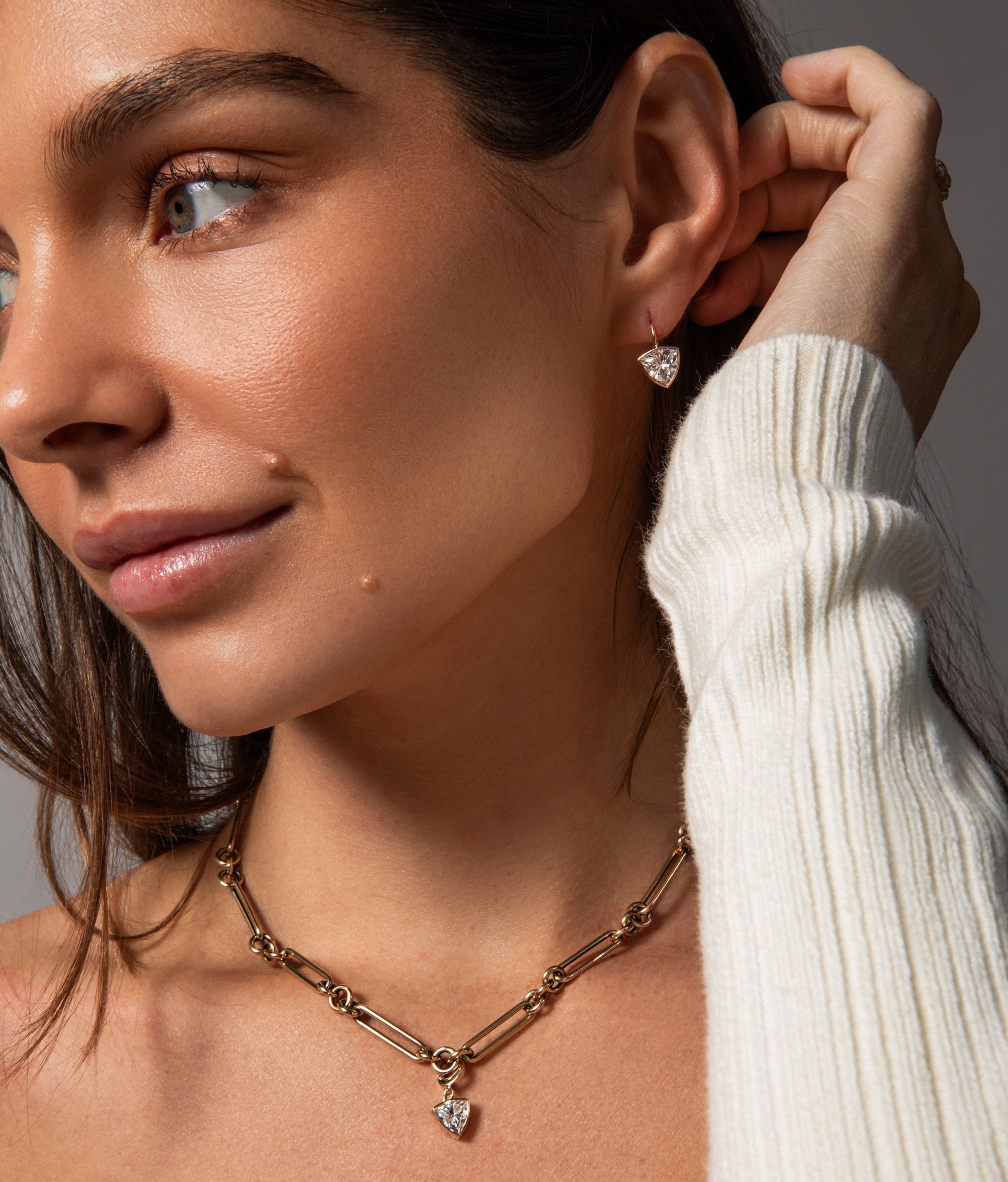 models wears trillion diamond earrings and necklace charm