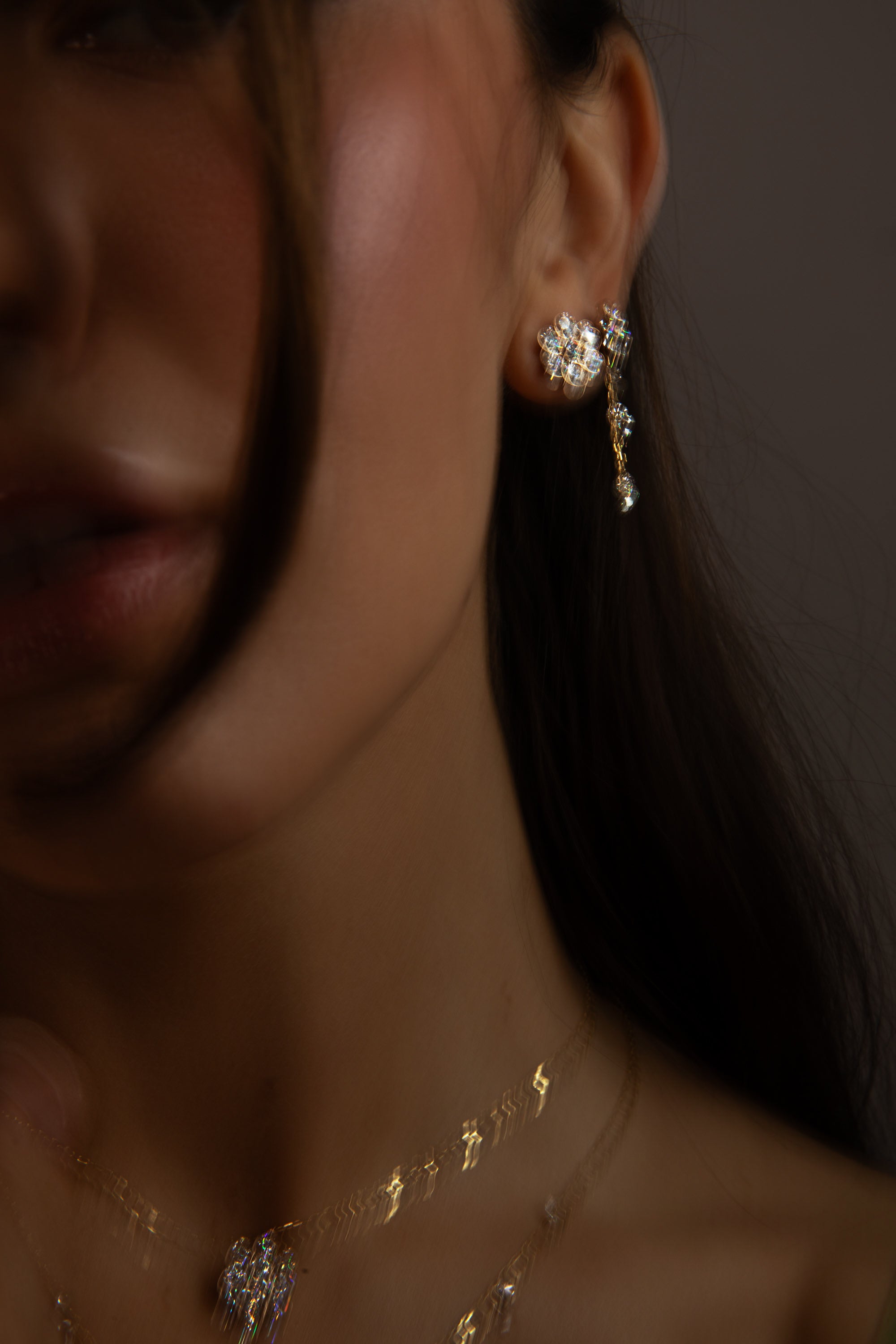a close up of a model wearing the diamond flower necklace and diamond flower studs from sophie ratner's summer 2026 Afterglow collection.