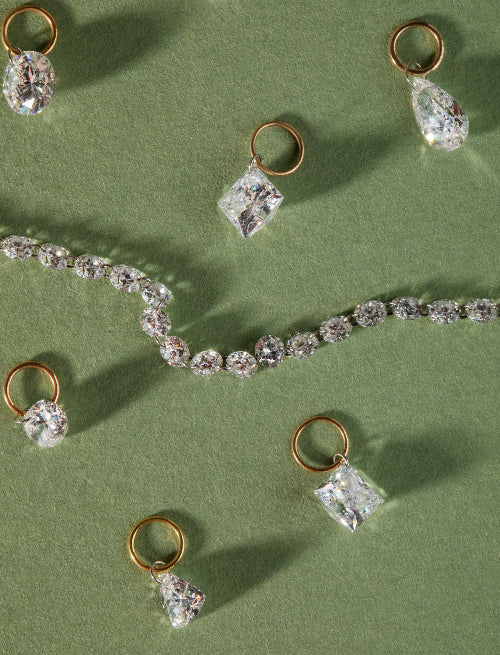 Gold and diamond jewelry on a green background