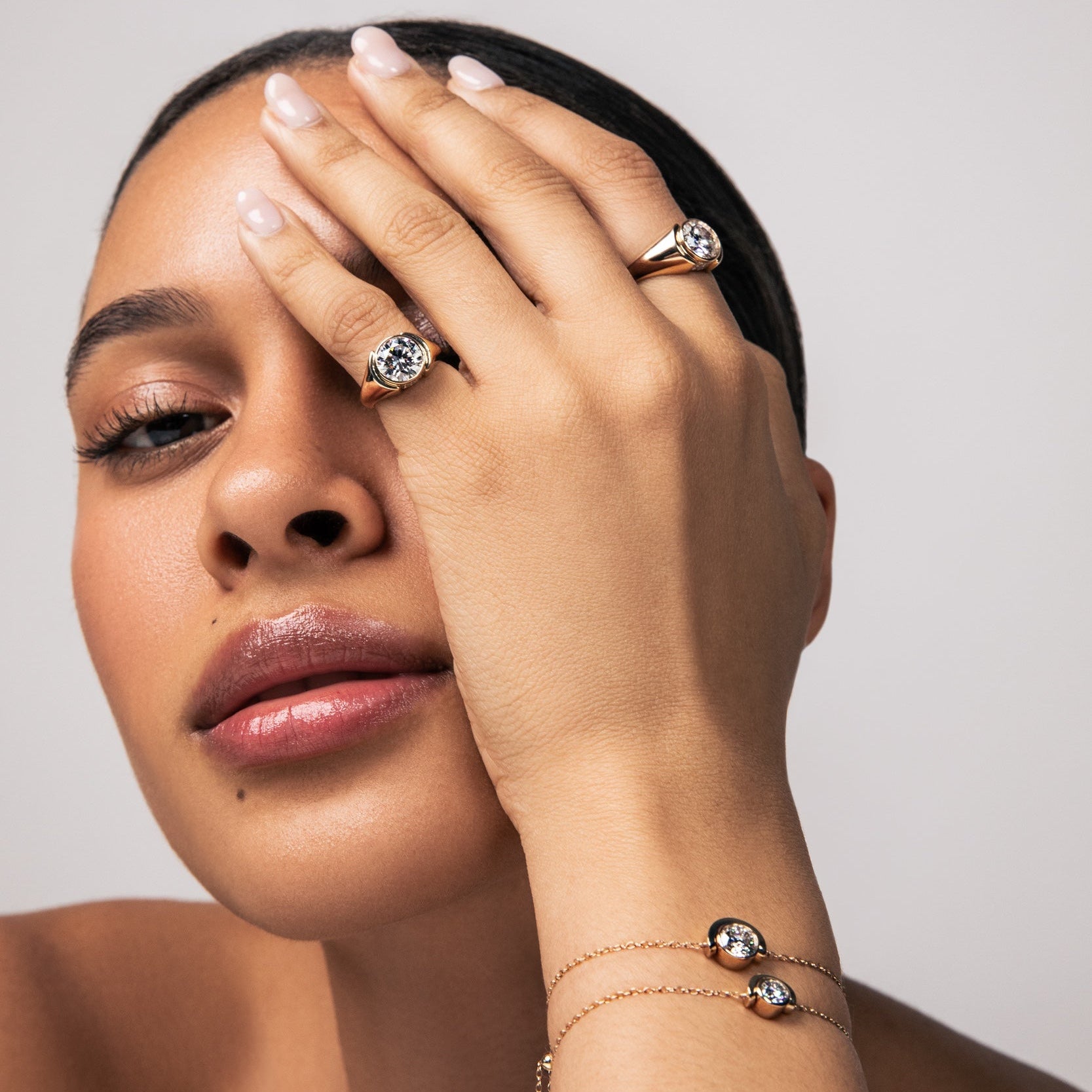 a model wearing new rings and bracelets from the timekeeper collection. Shop lab grown round diamonds and solid 14k gold designs now. 
